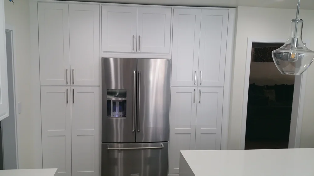White shaker wall of cabinets