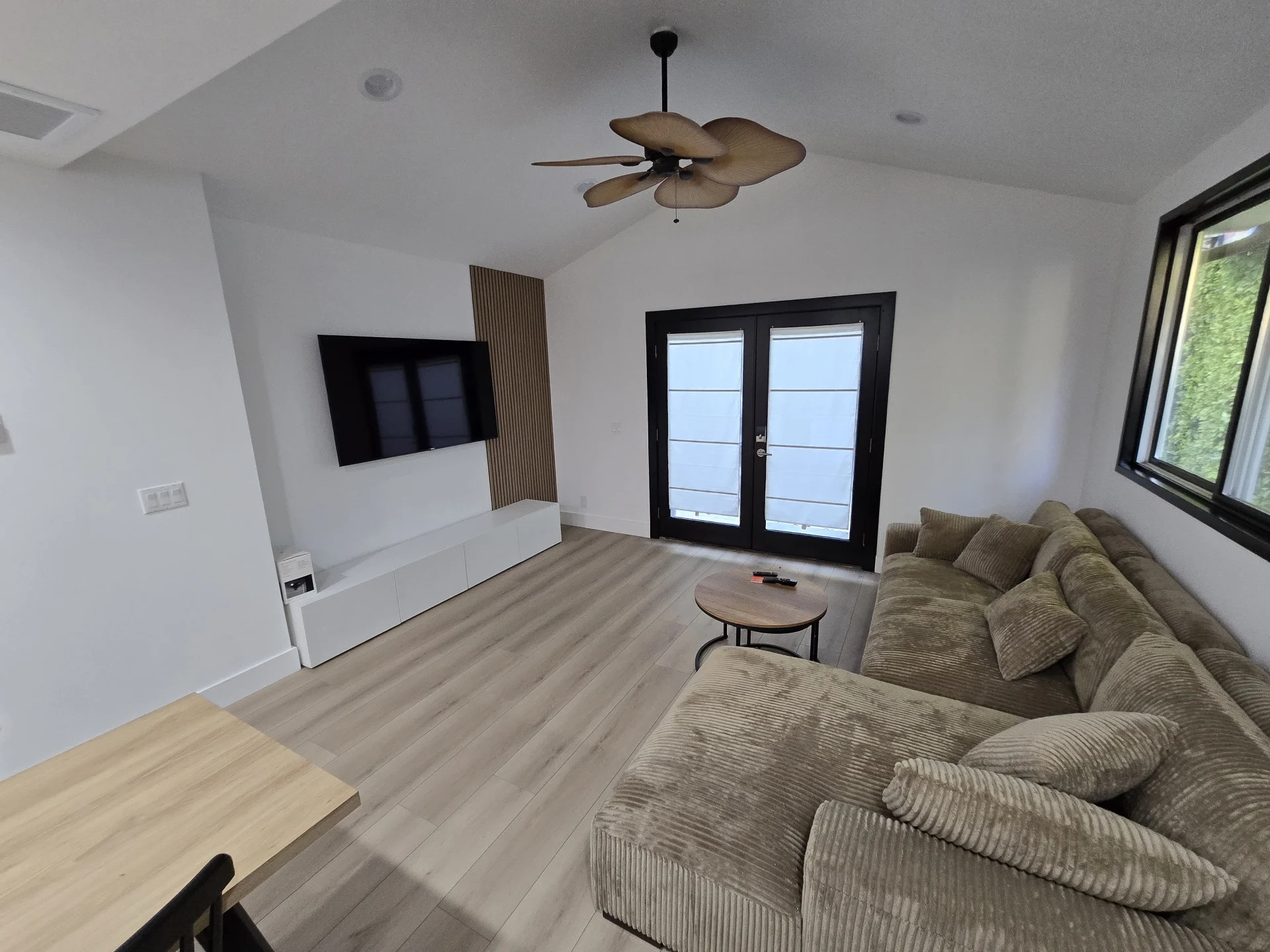 Vaulted living room with crisp white walls
